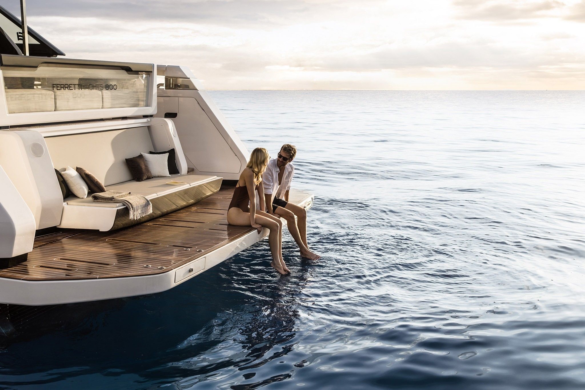 Two people relaxing on the Ferretti 800  beach area