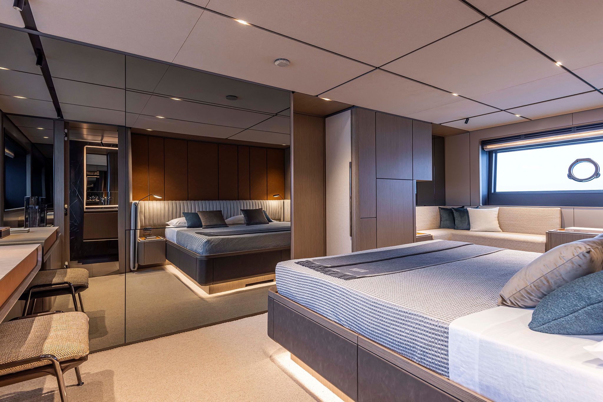 Modern Ferretti yacht bedroom with a large bed and soft lighting.