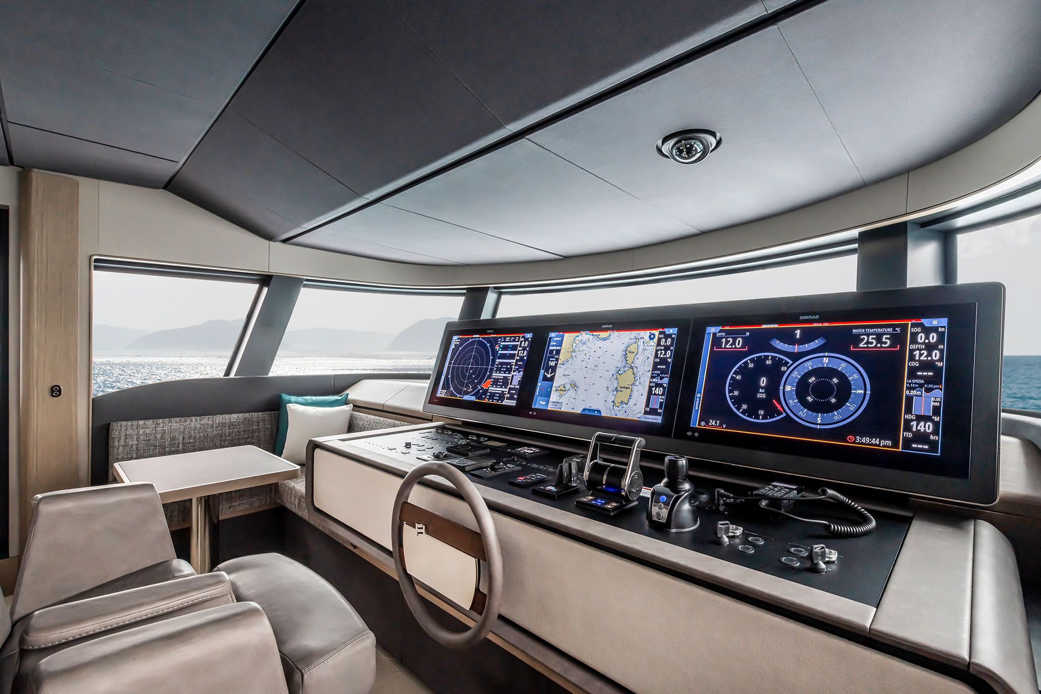 Advanced Ferretti yacht cockpit equipped with touchscreen navigation panels and captain’s chair.