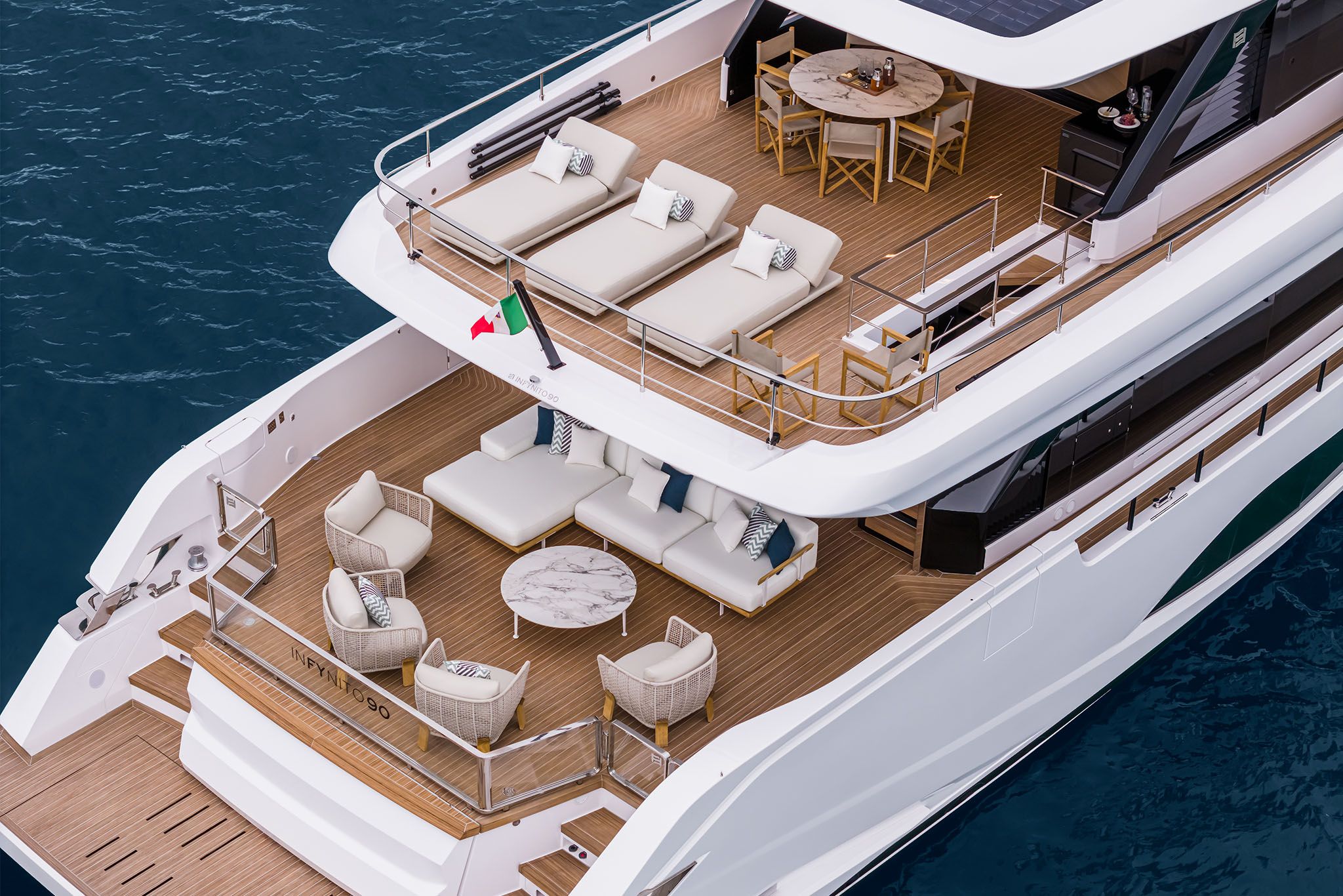 Multi-level Ferretti yacht, Infynito 90, showcasing its exterior with elegant outdoor seating and spacious decks.