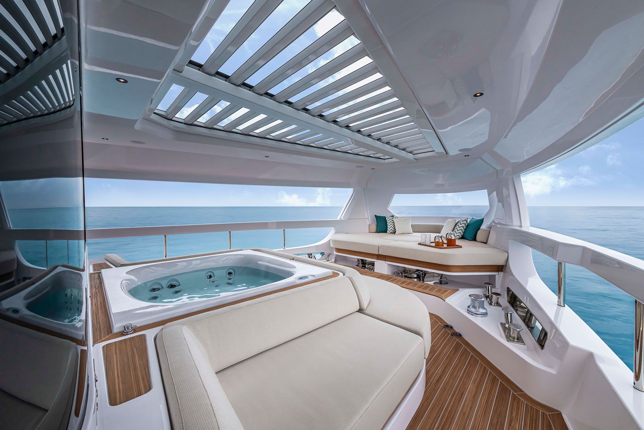Luxurious jacuzzi on the deck of Infynito 90, a Ferretti yacht, surrounded by elegant seating and ocean views.