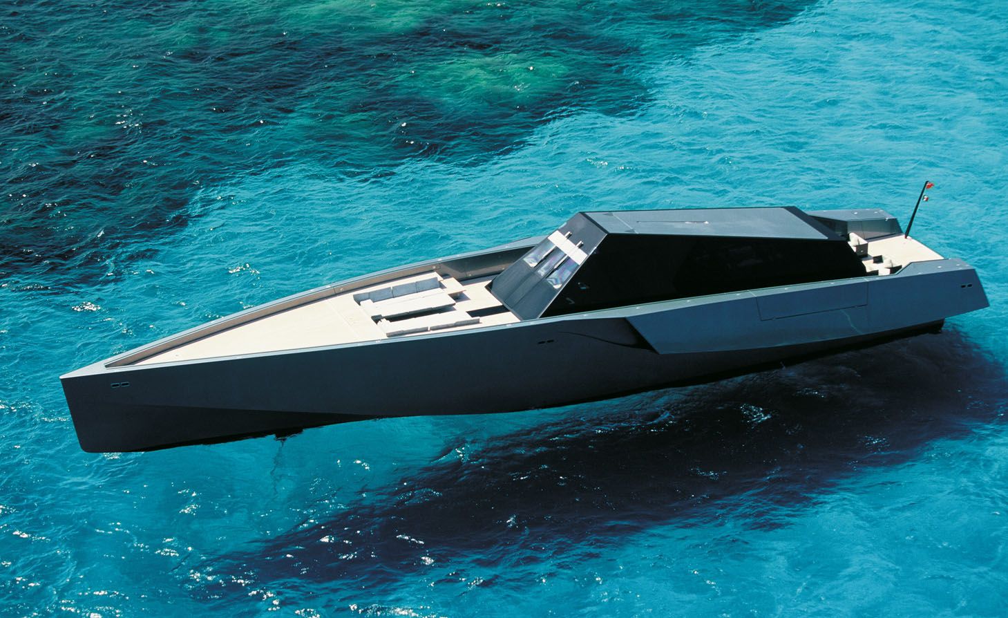 The Wallypower 118 yacht floating on clear turquoise waters, showcasing its sleek, modern design.