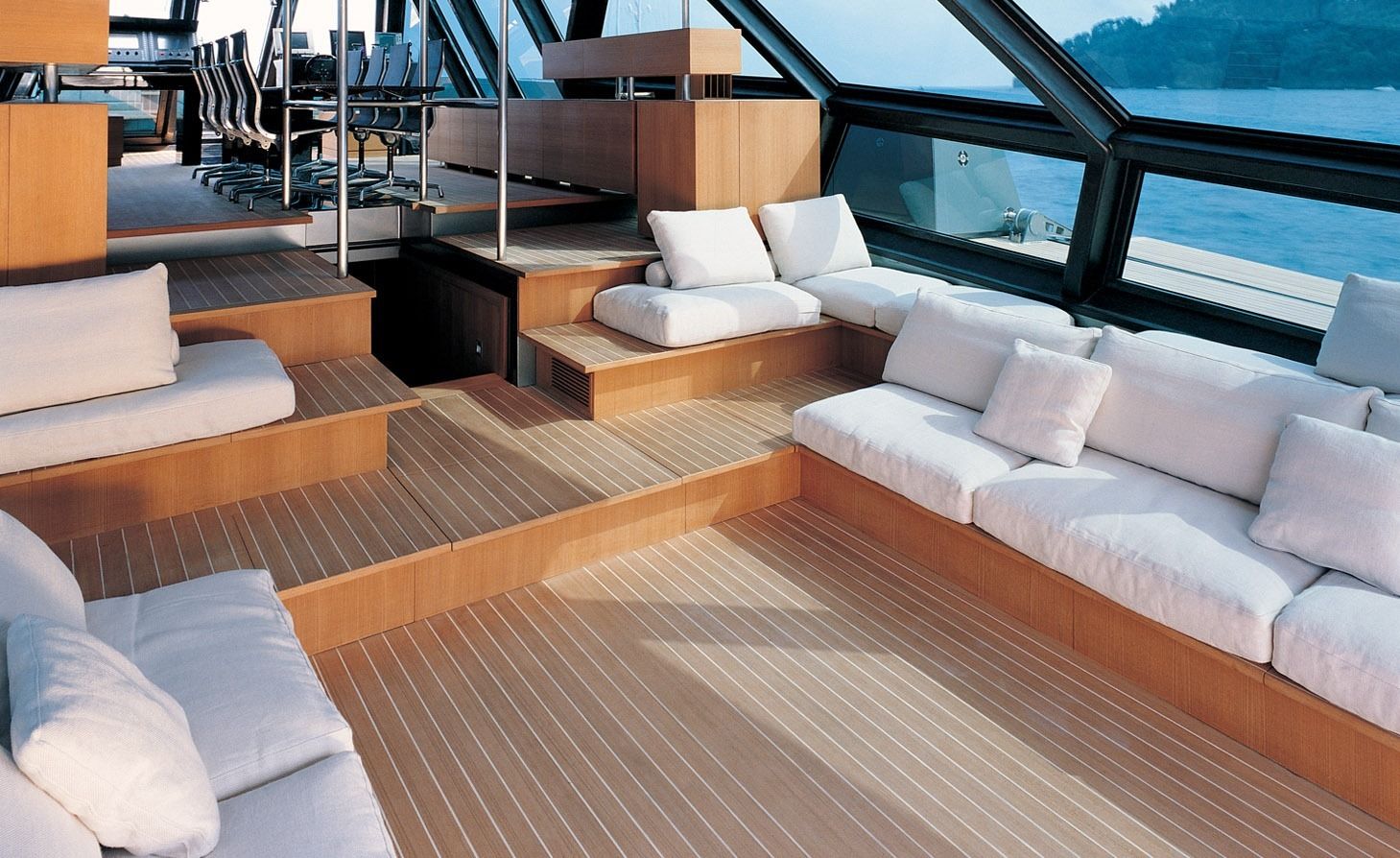 Yacht Interior: Interior of the Wallypower 118 yacht featuring tiered wooden floors and plush white seating.