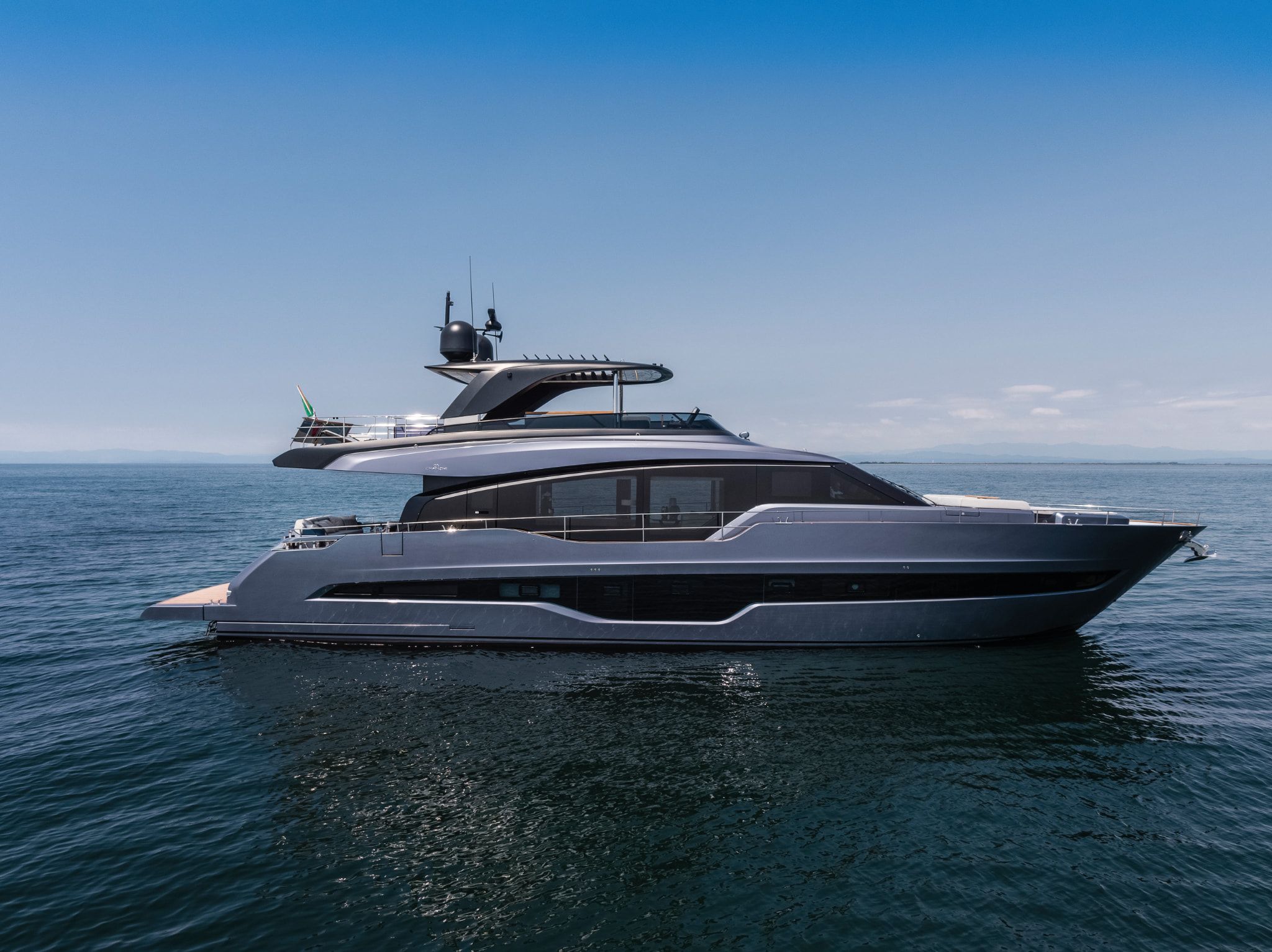 A beautiful white Cranchi Settantotto 78 showcased on the calm blue waters under a sunny day.