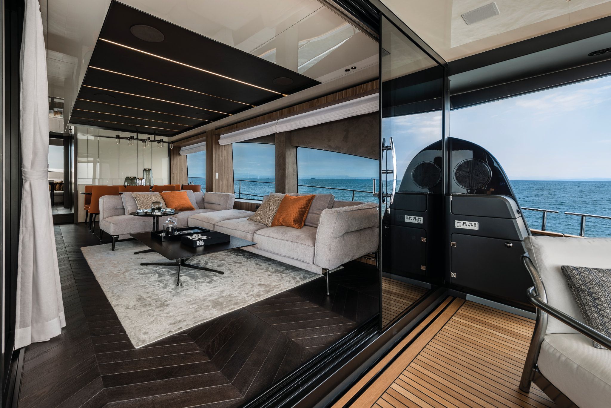 Yacht interior of Cranchi Settantotto, featuring lounge with plush seating and panoramic ocean views.