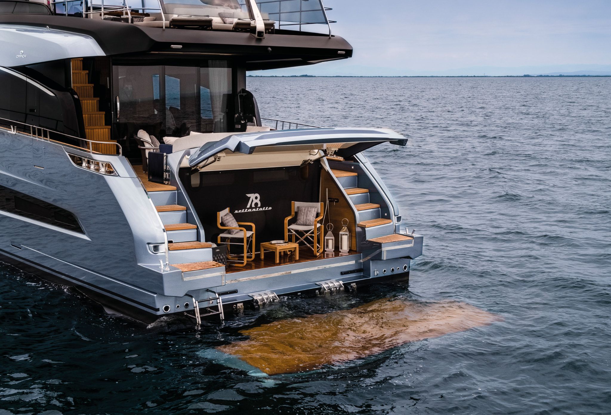 Cranchi Settantotto, yacht rear deck with a private lounge and easy water access.