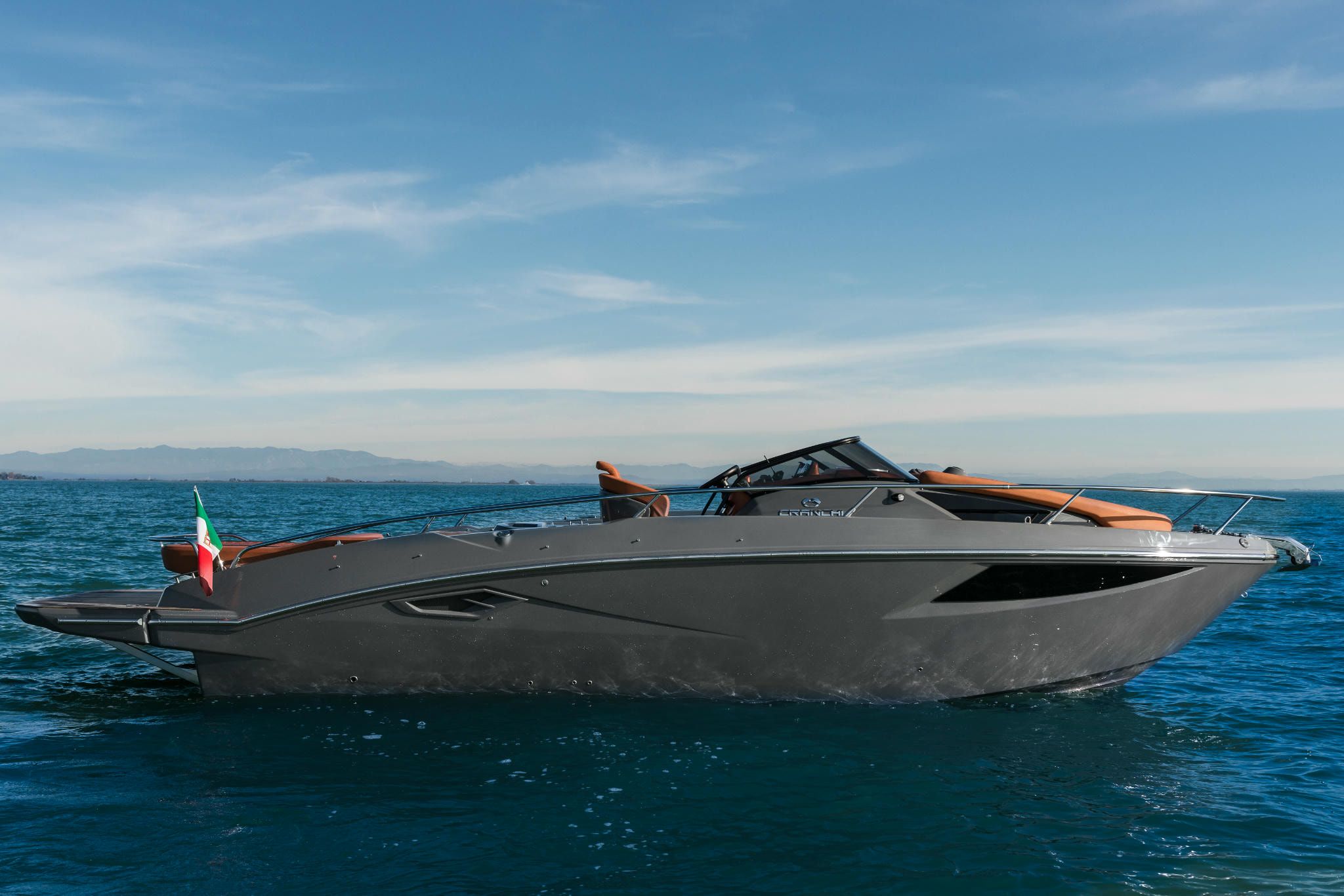 Cranchi Yacht: A grey and red Endurance 30 showing off its distinctive design, floating calmly on the sea.