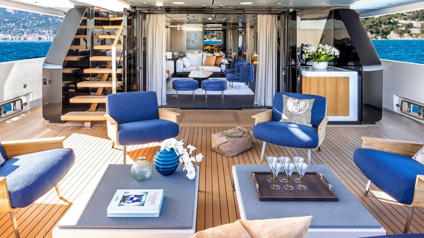 Custom Line 140 yacht interior with marble accents, leather furniture, and large windows.