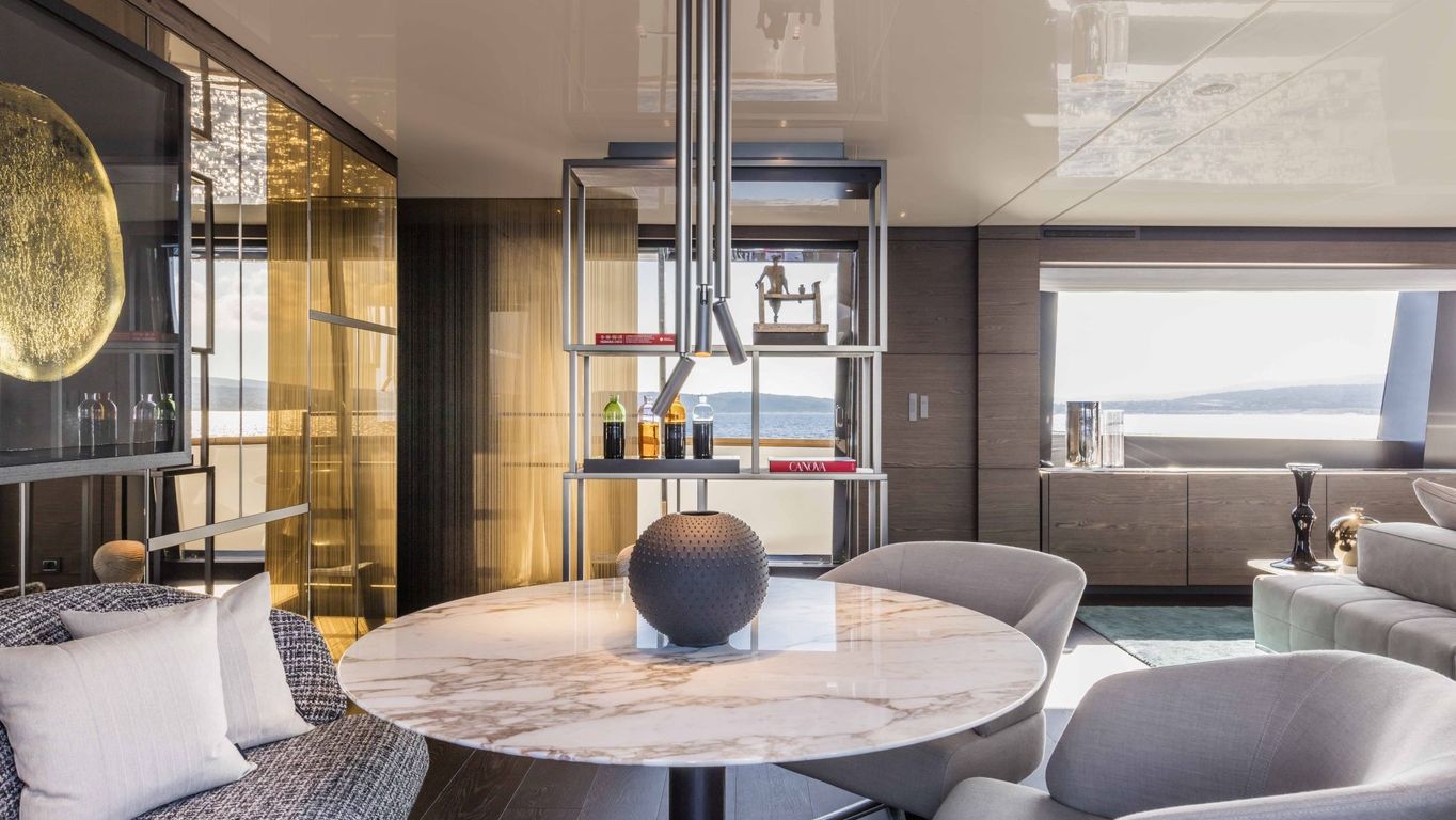 Custom Line Navetta 42 yacht interior by Starship Yachts, with modern decor, marble table, and ambient lighting.