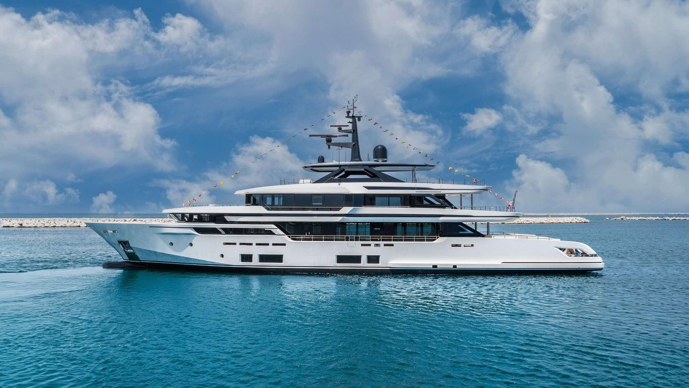 Large yacht, Ancona yacht, part of Ferretti Group's Custom Line, docked at a shipyard with waterfront views. Presented by Starship Yachts.