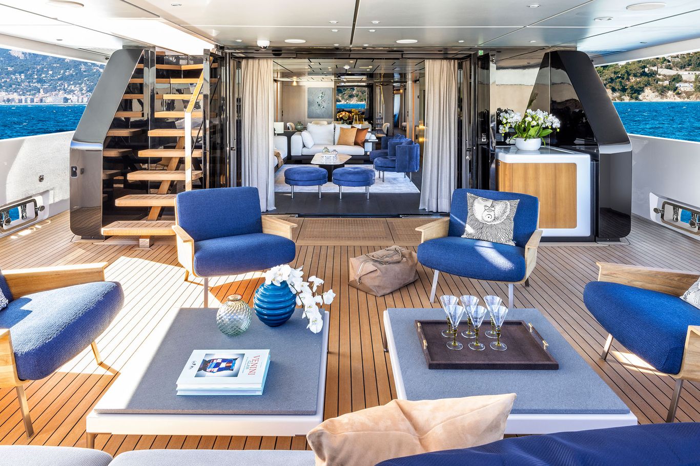 Custom Line 140 yacht interior with marble accents, leather furniture, and large windows.