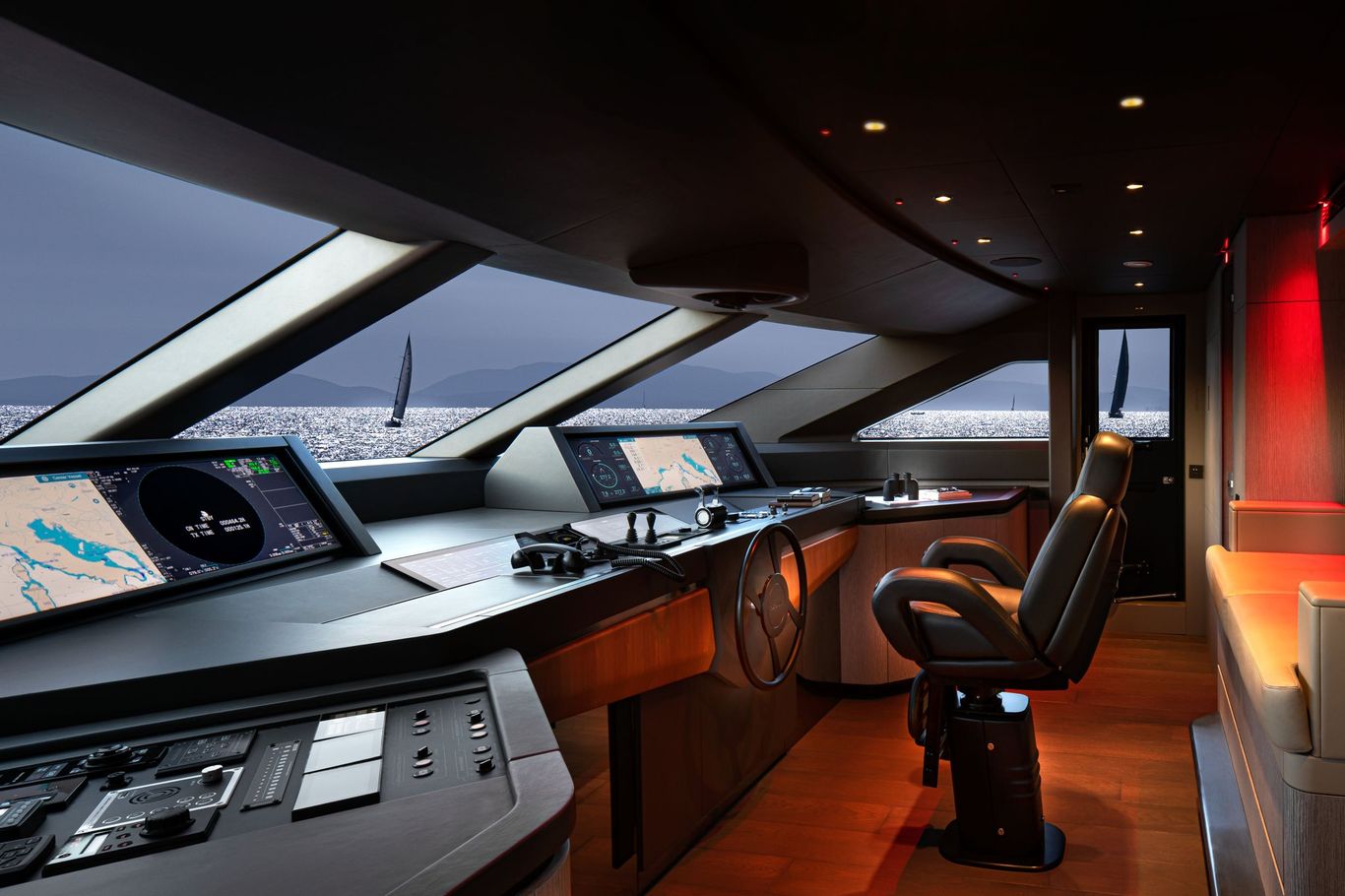 Advanced yacht control room with navigation screens, comfortable seating, and ocean view.