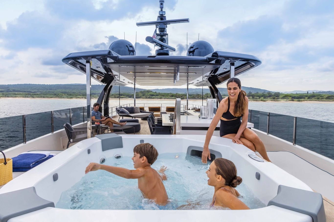 Spacious deck on Custom Line Navetta 42 yacht with a jacuzzi and comfortable seating for a family-friendly experience.