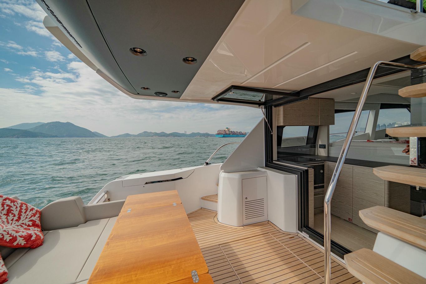 Spacious aft deck with teak flooring and alfresco dining area on Ferretti Yachts 500