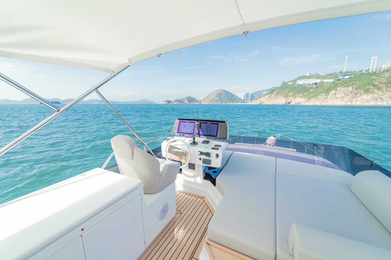 Flybridge helm on Ferretti Yachts 500 featuring white leather chair, sleek controls, and sea-facing layout