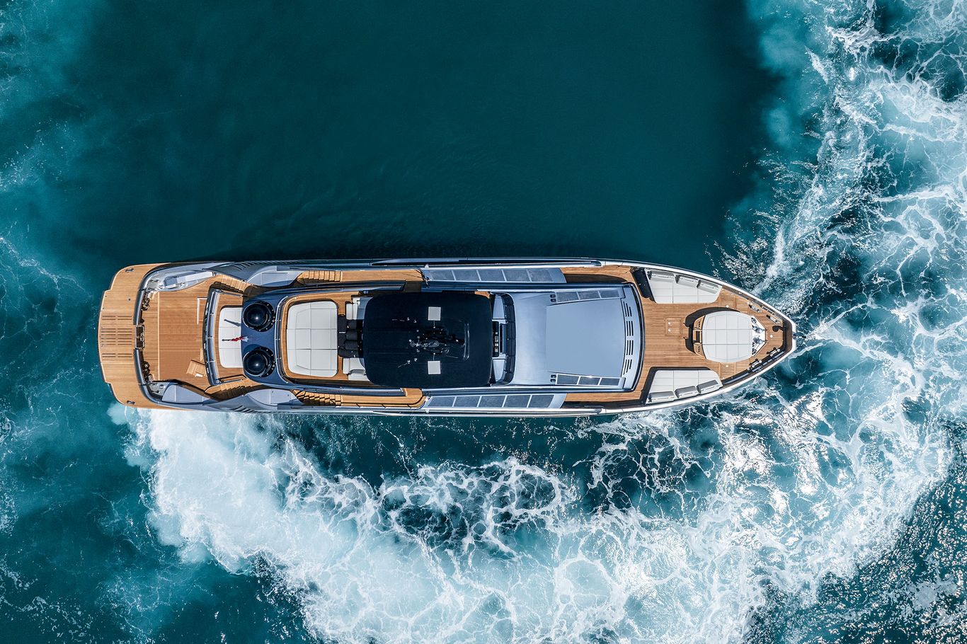 Ariel view of the dashing Pershing GTX 116 speeding through the ocean, surrounded by the vast blue waters.