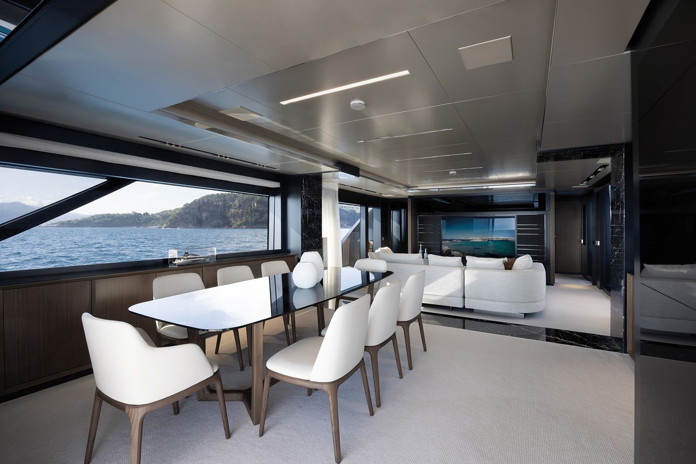 Open plan salon and dining area on the main deck of Riva 102 Corsaro Super designed for entertaining and comfort