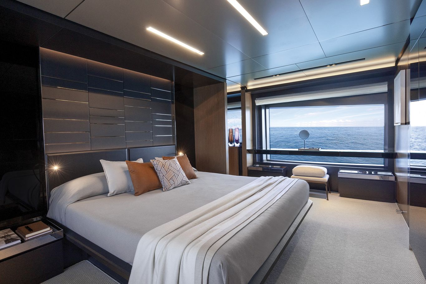 Master bedroom on the main deck of Riva 102 Corsaro Super showcasing luxury finishes large windows and serene ambiance