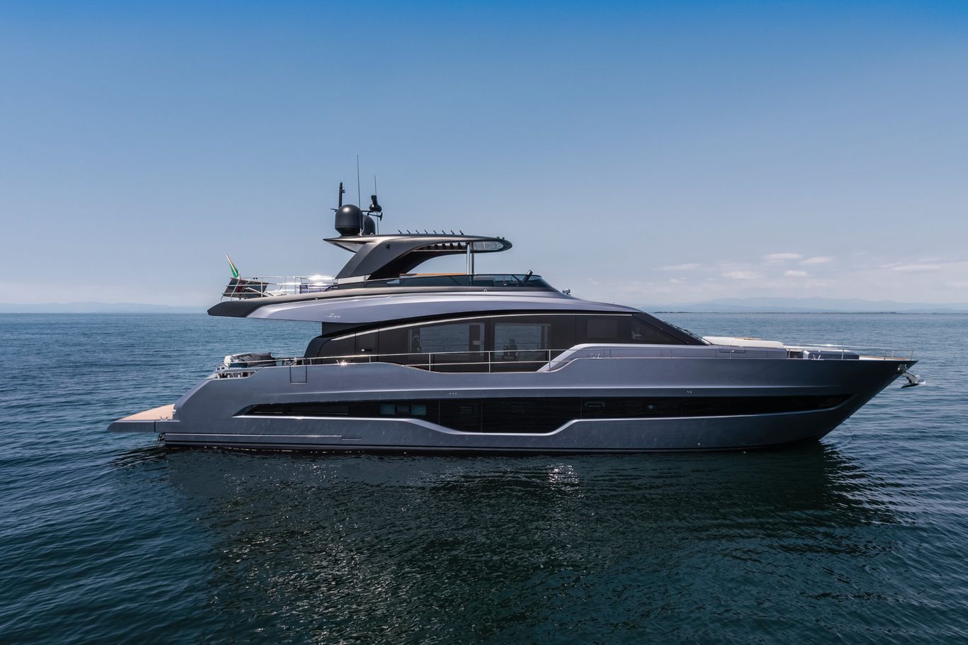 A beautiful white Cranchi Settantotto 78 showcased on the calm blue waters under a sunny day.