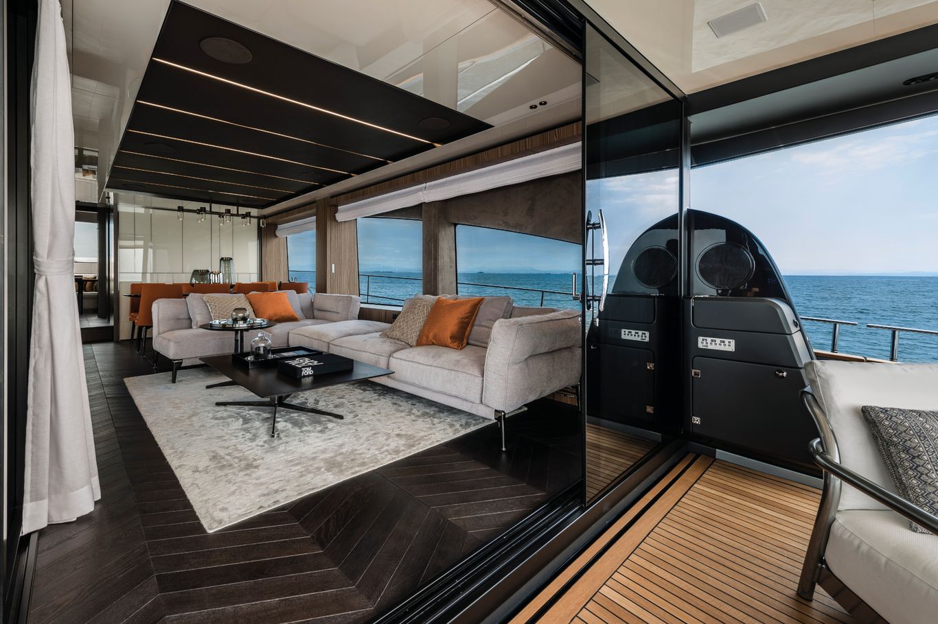 Yacht interior of Cranchi Settantotto, featuring lounge with plush seating and panoramic ocean views.