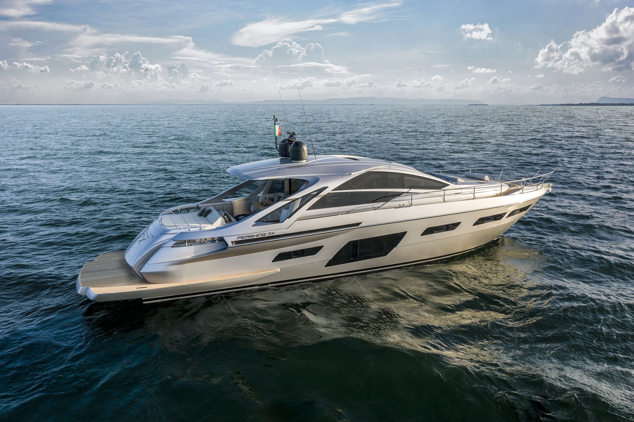 A stylish white Pershing 7X floating graciously on the open sea under a bright sky.