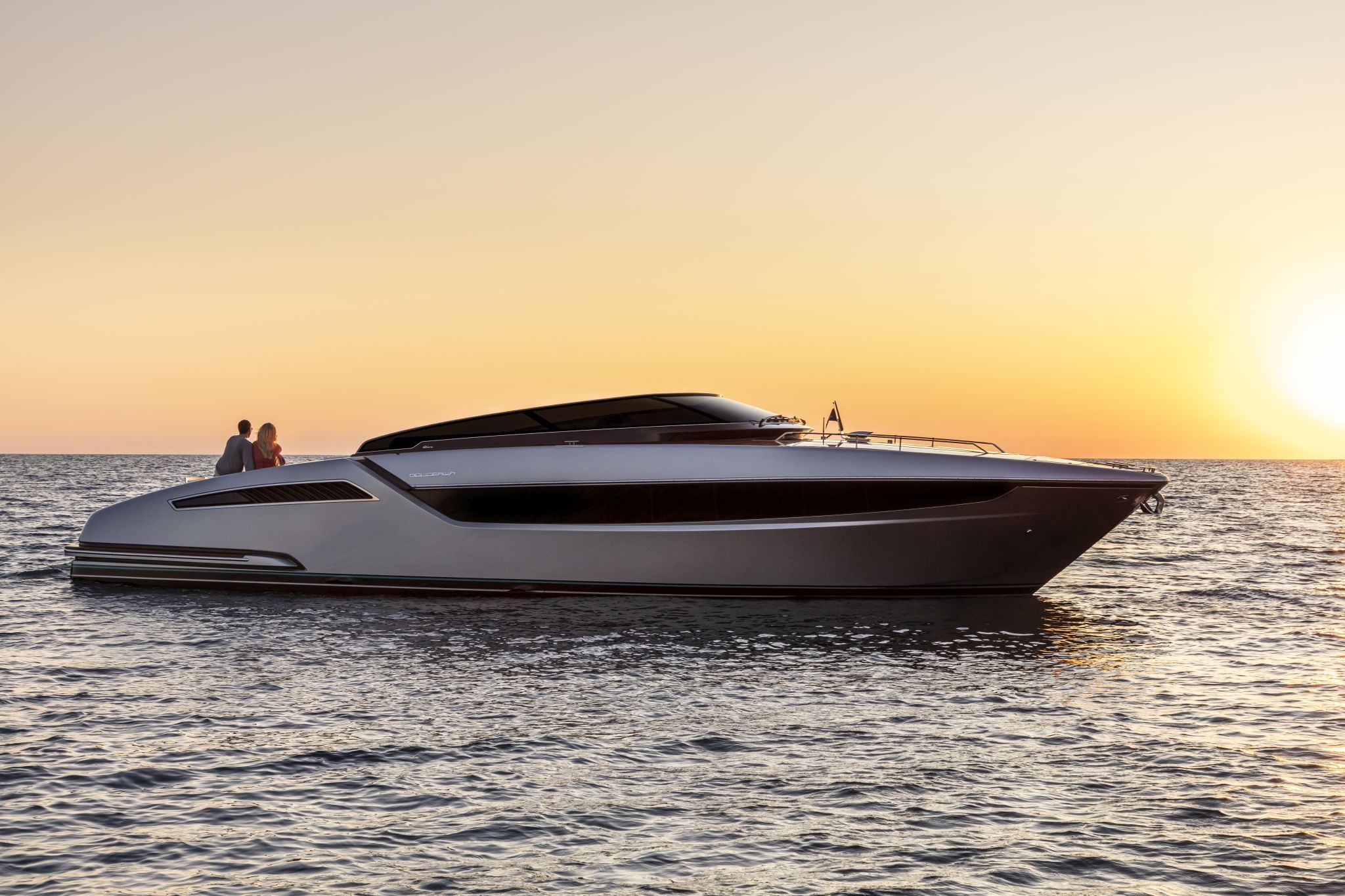 Riva Yacht: A black and white Dolceriva showcased on the open water during a beautiful sunset.
