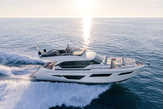 Starship Yachts: A sleek, white Ferretti Yachts 580 cruising stylishly on the blue ocean water, leaving splashes of water.