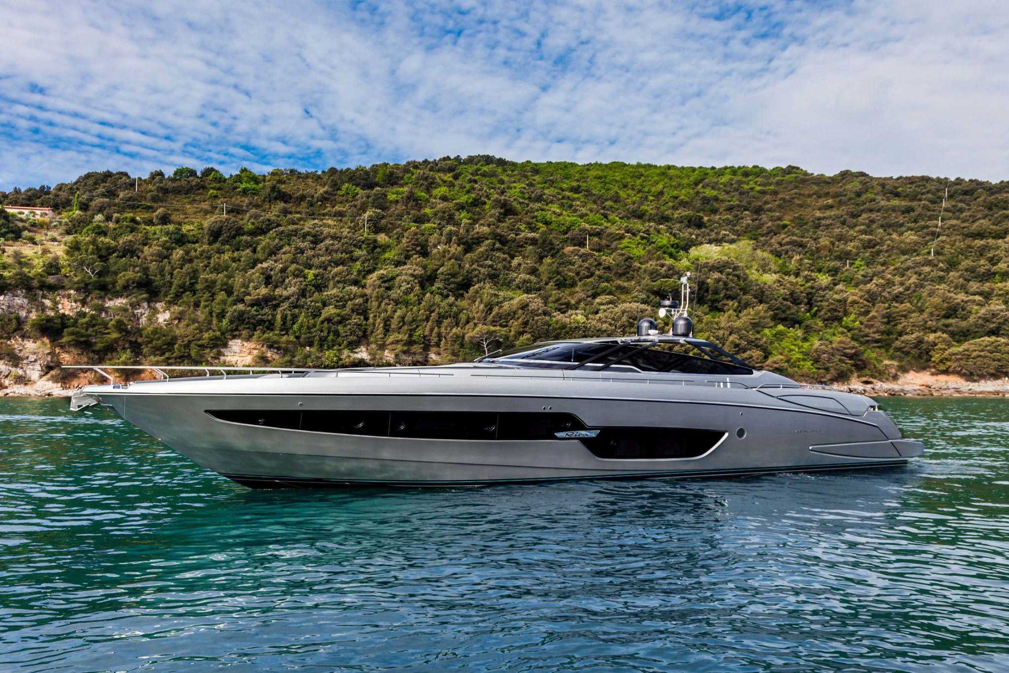 Riva Yacht: A sleek, fancy 88'Florida floating gracefully on the water on a bright day.
