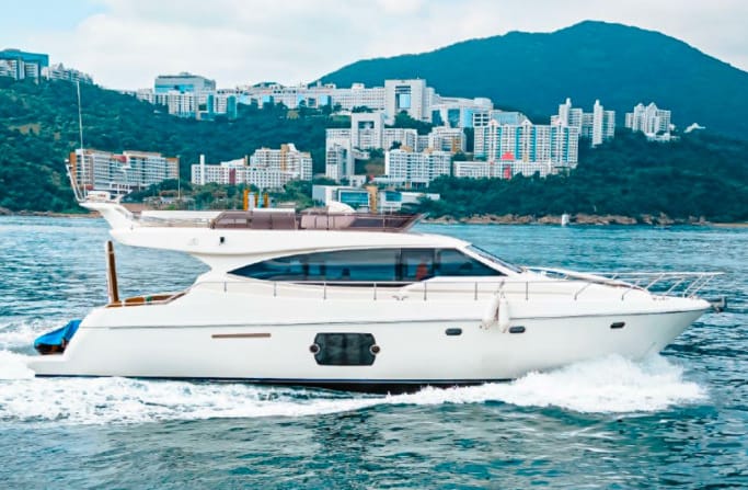 Luxury yacht broker: Ferretti Yachts FY510, cruises through a seaside city.