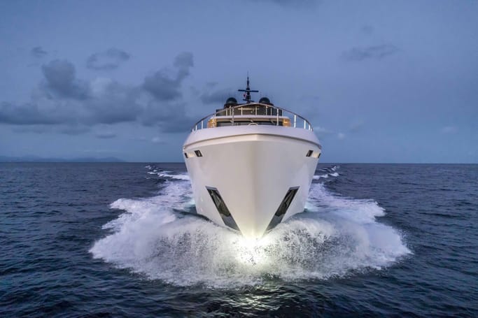 Custom Line Navetta 42 cruising along a coastline at the 65–75 metre sweet spot.