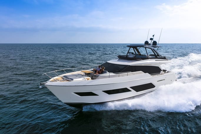 A modern, white Ferreti Yachts 720 showcased for sale as it cruises on the sea, under a blue sky.