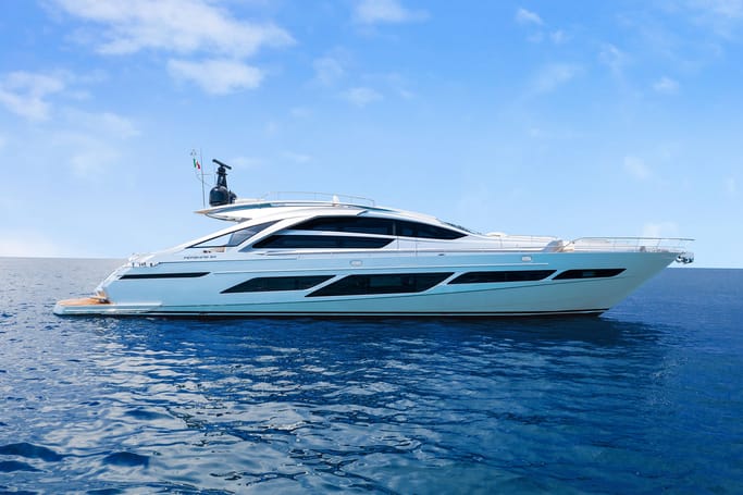 An elegant and modernized white Pershing 9X floating in the deep blue sea under a bright day.