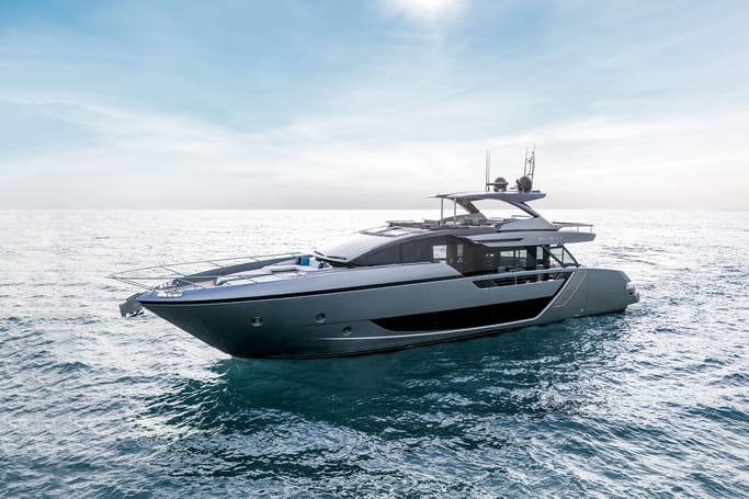 Luxury Riva Yacht : Riva 82'Diva gliding through ocean waves on a sunny day.