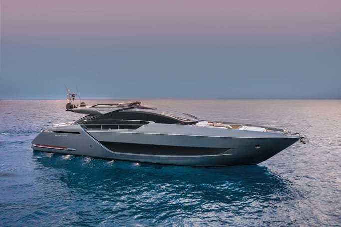 A white and black 88'Folgore by Riva sailing through the ocean under a beautiful sky.