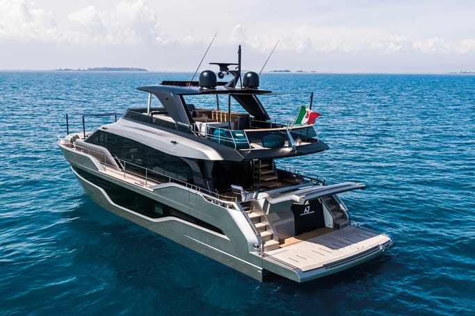 Cranchi Yacht: A luxurious triple-decked Sessantasette 67 showcasing its elegance on a calm blue sea.